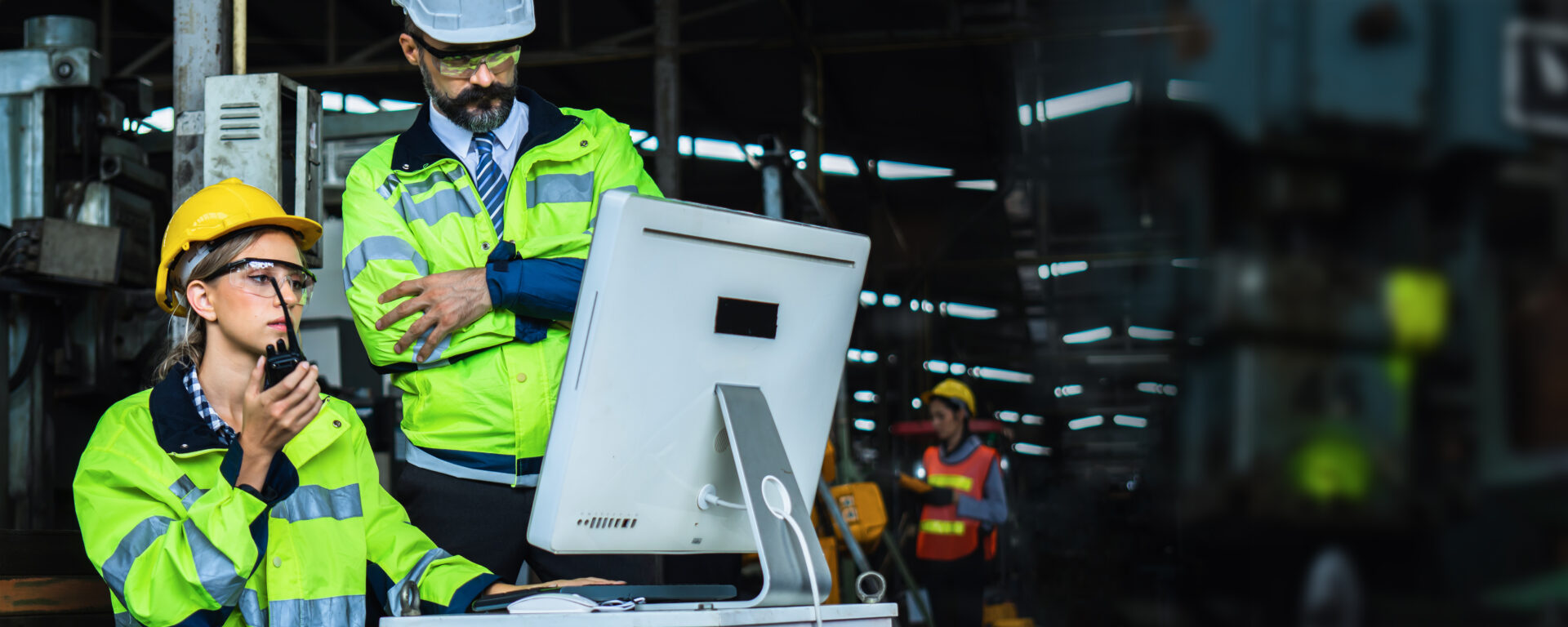 Managers on construction site checking things on computer